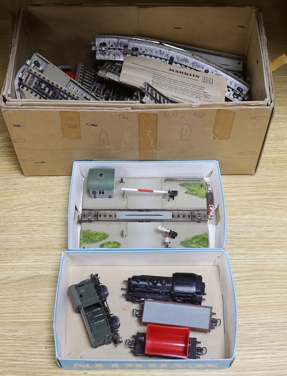 A German Marklin 7390 miniature rail station, tracking, engine and carriages, with original booklet